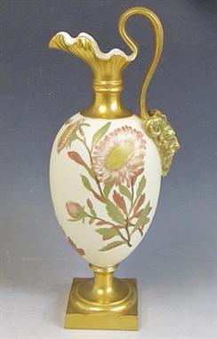 A late 19c Royal Worcester pedestal ewer vase with a floriform gilded neck and Bachanalian mounted handle, the body decorated