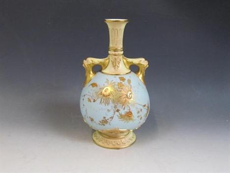 A late 19c Royal Worcester pedestal vase of globular form with a tapering neck supported by two dolphin mask handles, the bod