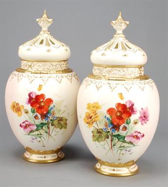 A pair of Royal Worcester blush ivory ground pot pourri Rose Jars, liners and pierced covers, variously decorated with floral