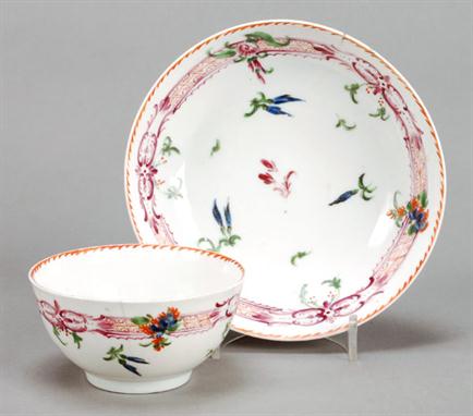 Bristol porcelain (Richard Champion) polychrome teabowl and saucer, painted with scattered floral buds within a rocaille band