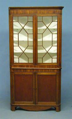 A MID 19TH CENTURY WELSH OAK DOUBLE CORNER CUPBOARD, the upper part with moulded cornice  above a pair of astragal glazed doo