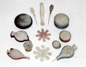 Mother of pearl items: four disc, two bellow and one fish form pin cushions, 7.5cm and smaller; t
