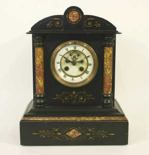 A Victorian belge noir marble eight-day mantel clock, the French gong-striking movement with two-