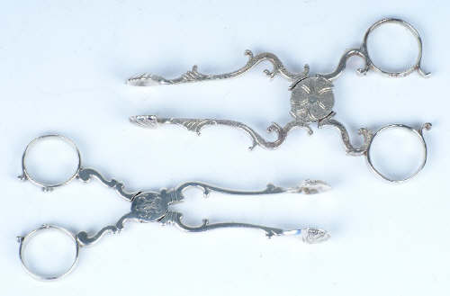 A pair of George III cast silver sugar nips, untraced maker