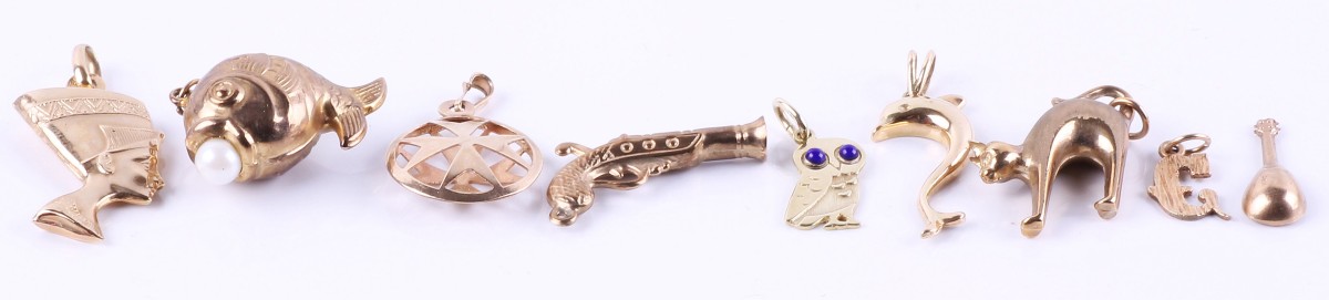A collection of five 9 carat gold charms, comprising: a fish with a cultured pearl to its mouth, 
