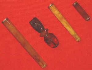 Four amber cigar holders, C19th, one carved, lengths 19cm, 14cm, 11cm, 6cm.