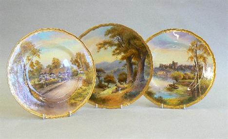 Three Royal Worcester plates decorated with landscapes. 
