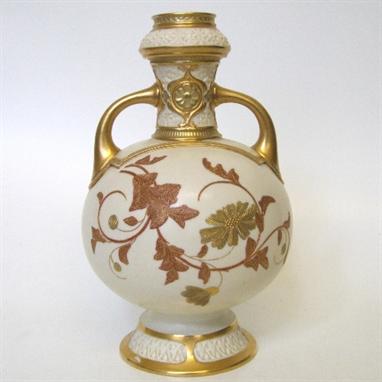 Royal Worcester twin handled vase decorated with raised gilt leaves and flora, with moulded collar and foot, green printed 10