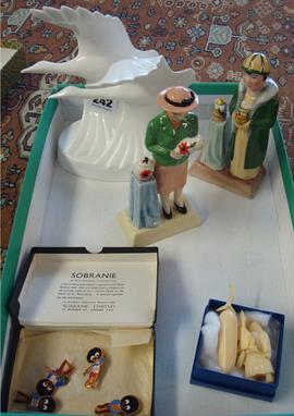 Marine ivory Inuit carving of a figure, other carvings, four Robertson Jam figure enamel badges, two Manor Susie Cooper and C