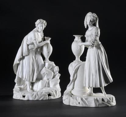 A PAIR OF MINTON BISCUIT FIGURES OF ARABIA AND PERSIA personified as a young woman with a vase or ewer on draped plinth or ro