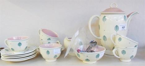 Susie Cooper coffee set, of cream ground decorated with green foliate leaves with pink glaze inside, comprising coffee pot, s