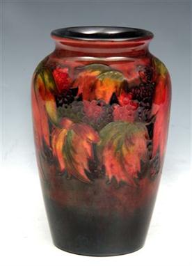 A MOORCROFT FLAMBE LEAF AND BERRY DESIGN TAPERING VASE, impressed Moorcroft Potter to Her Majesty The Queen signature to the 