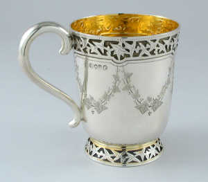 A Victorian christening mug, decorated with engraved festoons of  ivy, a blind fret frieze of ivy leaves and a flared  foot a