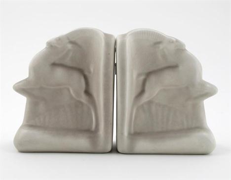  A pair of Pilkington`s Royal Lancastrian book ends, each modelled as a leaping Ibex, glazed matt white-grey impressed marks,