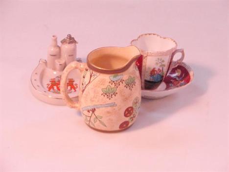 A Royal Worcester cream ware jug, decorated in red, green and blue with aesthetic designs, 12cm high, a Goss crested china ho