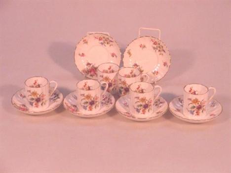 A Royal Worcester coffee set, Roanoke pattern, comprising six coffee cans and saucers, each of fluted form, printed in colour