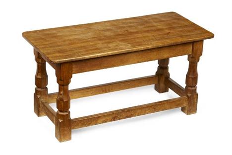 ROBERT (MOUSEMAN) THOMPSON OAK COFFEE TABLE, CIRCA 1950 the rectangular top with adzed surface raised on faceted turned and b