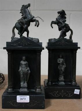 A pair of Victorian slate pedestals of architectural form, each mounted with a spelter Marly horse above a classical figure, 