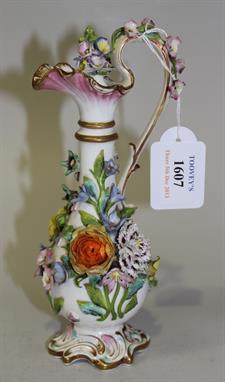 A Staffordshire porcelain flower encrusted ewer and stopper, probably by Minton, circa 1820, the slender baluster body and sc