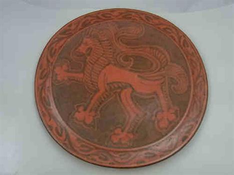 Royal Lancastrian William S. Mycock Pottery Plaque, having red mottled decoration of a lion, 31.5cm diameter