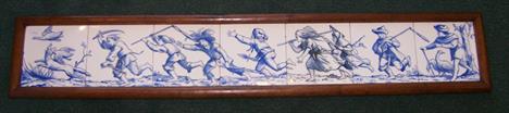 A series of seven Minton blue and white Tiles forming a tableau of children chasing a fox with a duck in its mouth, in oak fr