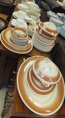 A collection of Susie Cooper dinner wares decorated with feathers within a graduated brown border (mostly seconds), together 