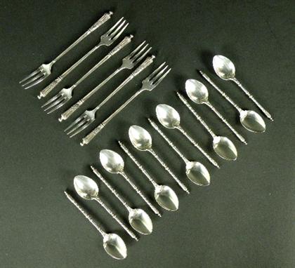 A set of twelve Christofle tea spoons, each with twisted stem and foliate wrapped handle along with a set of six tea forks, e