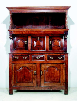 A Welsh joined oak press cupboard, second quarter 18th century, and associated later canopy, the 