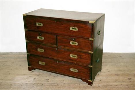 A reproduction mahogany campaign chest with secretaire drawer above two short and two long drawers, on bracket feet. 42ins wi