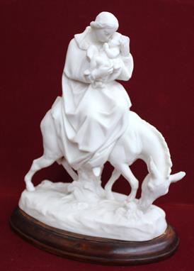 A Minton Parian figure group: &quot;The Flight Into Egypt&quot; modelled as The Virgin cradling Jesus, astride a donkey, impr