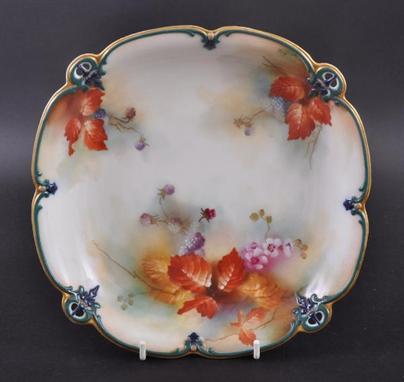 AN EARLY 20TH CENTURY ROYAL WORCESTER PLATE BY KITTY BLAKE painted with flowers and foliage. Signed. Mark in puce to undersid