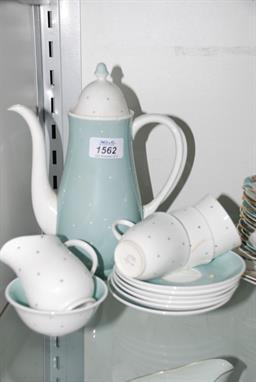 A Susie Cooper part Coffee Set comprising Coffee Pot, Sugar Bowl, Cream Jug, three cups and six saucers in pale blue and whit