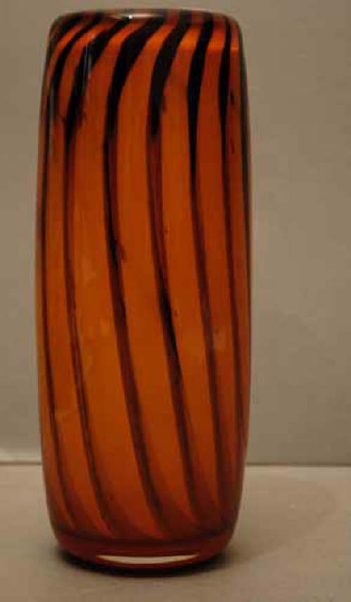 A Whitefriars glass orange vase from the striped studio range designed