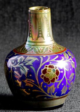 A Pilkingtons Royal Lancastrian lustre ware vase of bulbous form with cylindrical neck, decorated with stylised flower head a