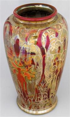 A Pilkingtons Royal Lancastrian lustre ware vase of cylindrical form, decorated with flowerheads on a red and green ground, i