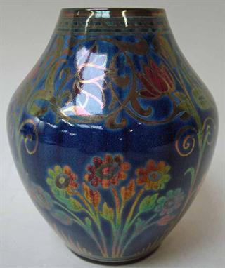 A Pilkingtons Royal Lancastrian pottery baluster vase, lustre-decorated on a blue ground with stylised plants by William S. M