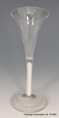 An 18th Century toasting glass circa 1765, a slender trumpet bowl above a double series opaque twist outside central guaze an