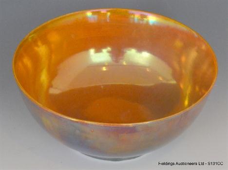 A 1930`s Pilkington Royal Lancastrian bowl decorated to the interior with an all over orange lustre glaze and to the exterior