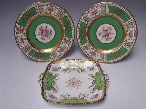 TWO DECORATIVE MINTON CABINET PLATES PAINTED BY J COLCLOUGH, white ground with floral &amp; green alternate panels to the edg