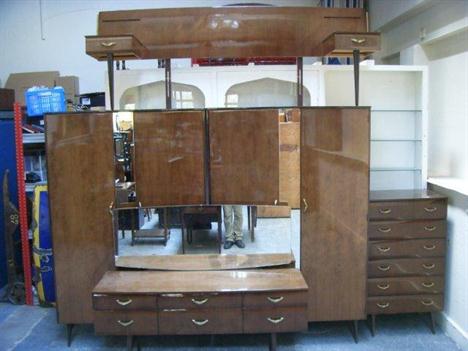 A 1950`s Rebo bedroom suite comprising two wardrobes, a chest of drawers, dressing table and twin headboard with attached bed