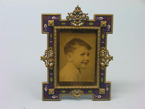 A 19th century French champleve-enamelled brass photograph frame, architectural form with cast scroll detail, champleve-ename