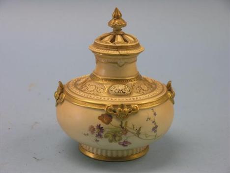 A late Victorian Royal Worcester pot-pourri vase, enamelled with flowers against a blush ivory ground, complete with pierced 