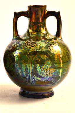A Pilkington's Lancastrian twin handled vase, the globular body lustre decorated with dragons and rosettes on a green ground,