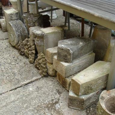 A collection of reconstituted stone architectural items to include coffin shaped markers