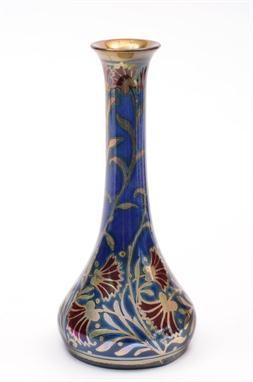 A Pilkington&#8217;s Royal Lancastrian vase of slender tapering form painted with red blooms on lustrous foliage reserved on 